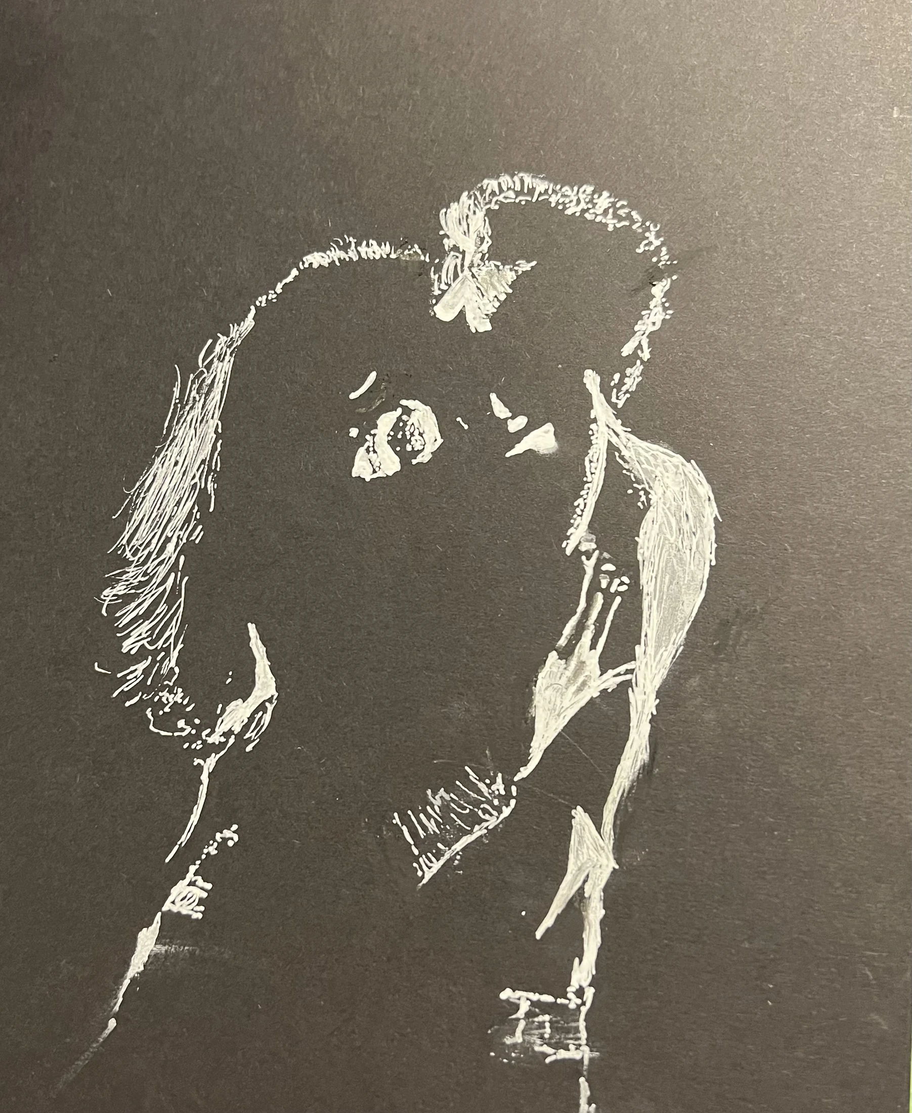 White line drawing of two figures embracing on dark paper